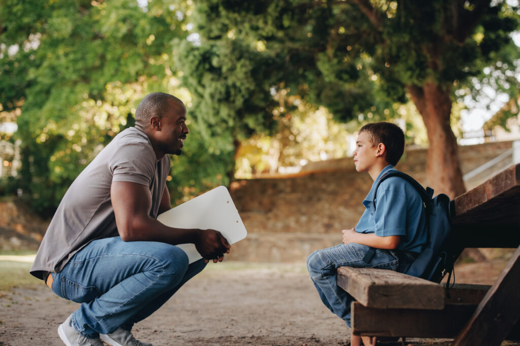 Man talking encouragingly to young man.